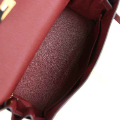Red leather Hermès Kelly Retourne handbag interior with smooth lining and stitching