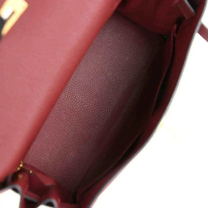 Red leather Hermès Kelly Retourne handbag interior with smooth lining and stitching