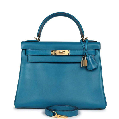 Hermes Kelly Retourne 28 bag in blue leather with gold lock, top handles, and strap
