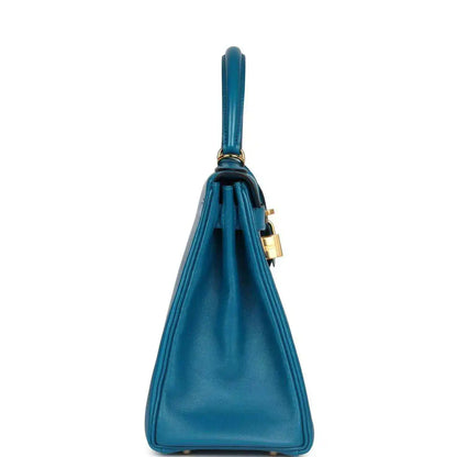 Hermes Kelly Retourne 28 bag in blue leather with top handle and attached shoulder strap