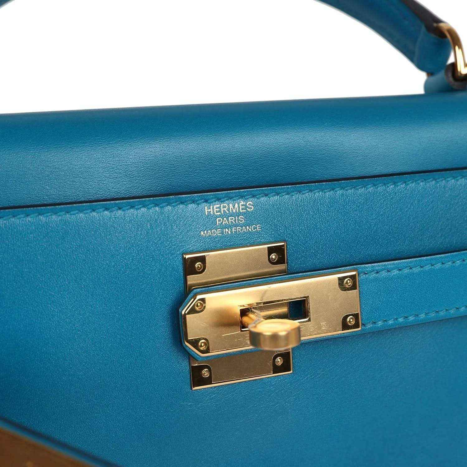 Hermes Kelly Retourne bag close-up of gold turn-lock with engraved Hermes branding