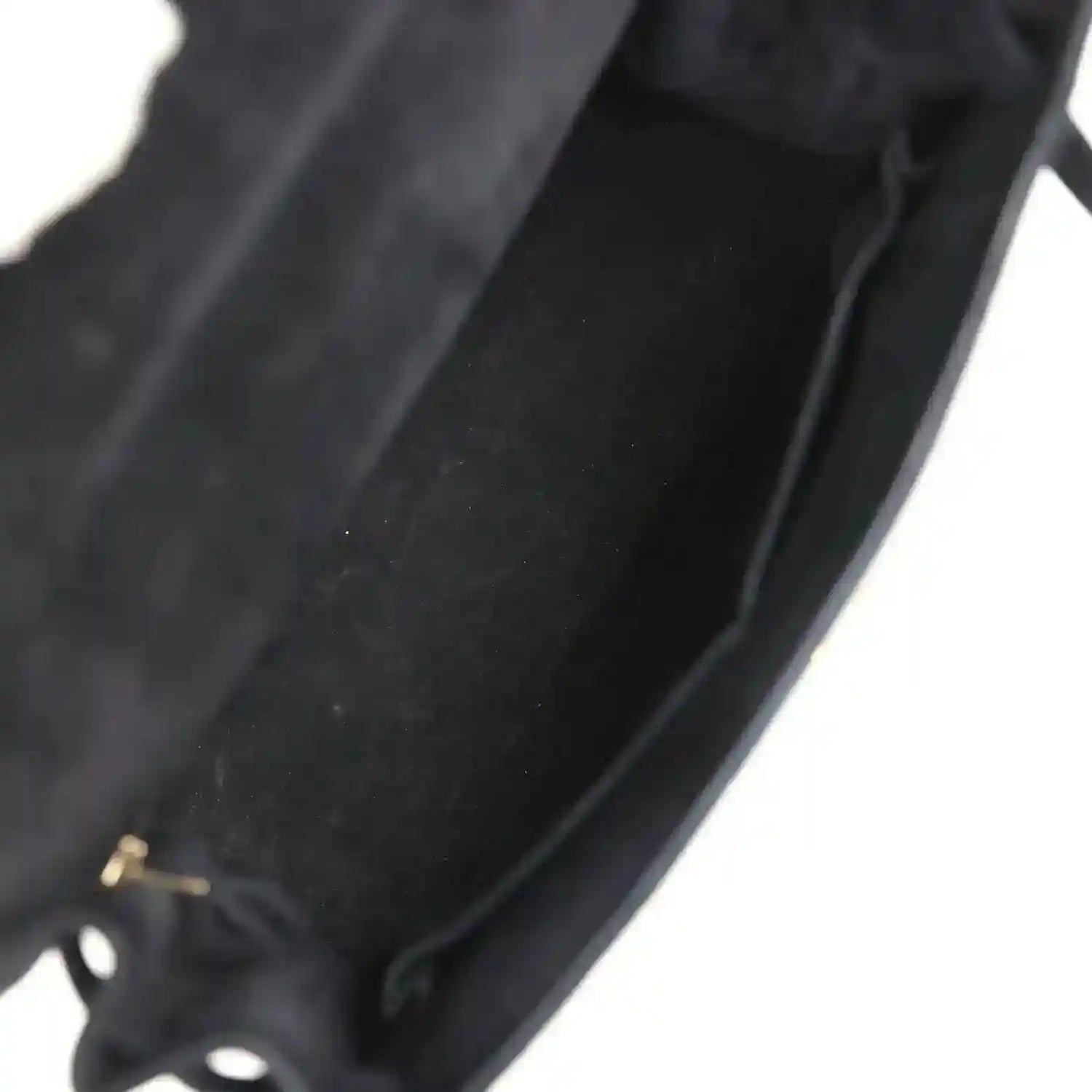 Black suede interior panel with stitched seam and curved edge