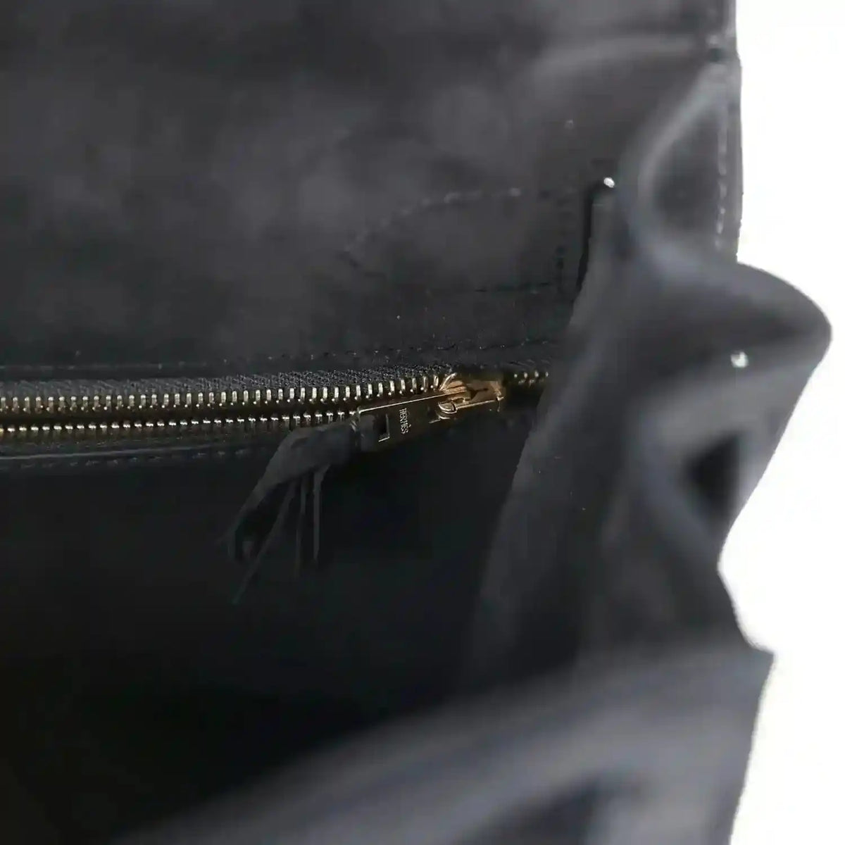 Black suede interior with gold zipper and small tassel pull