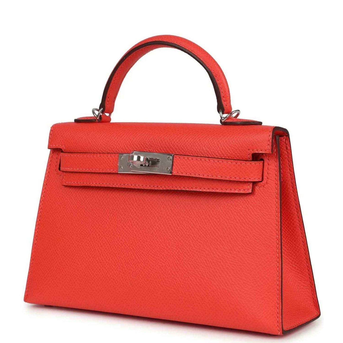 Hermes Kelly Sellier 20 orange-red bag with top handle and front flap, angled view