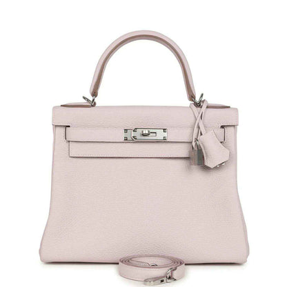 Light mauve leather handbag with top handle, front flap, and silver-tone clasp hardware