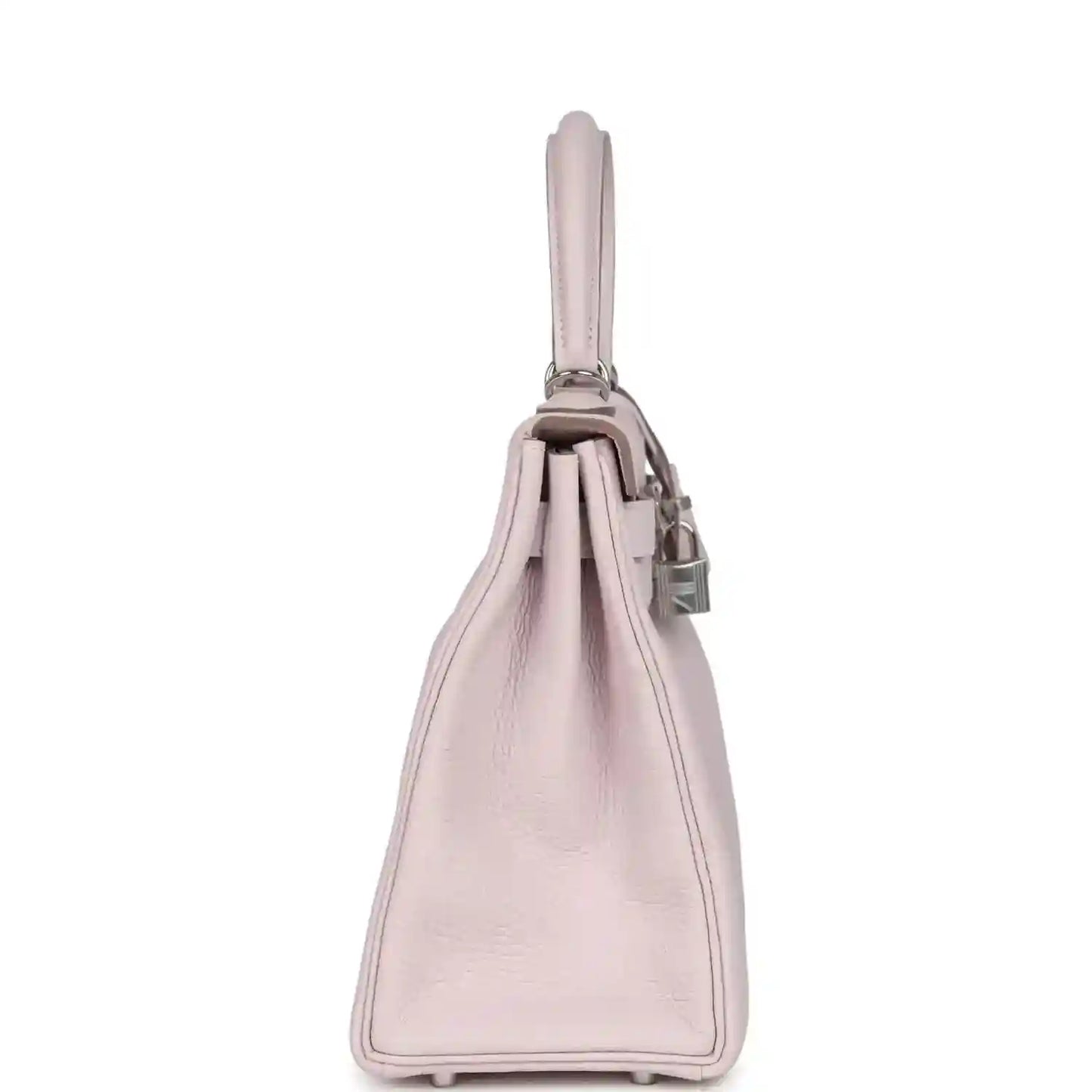 Light mauve leather handbag side view with top handle and stitched base corners