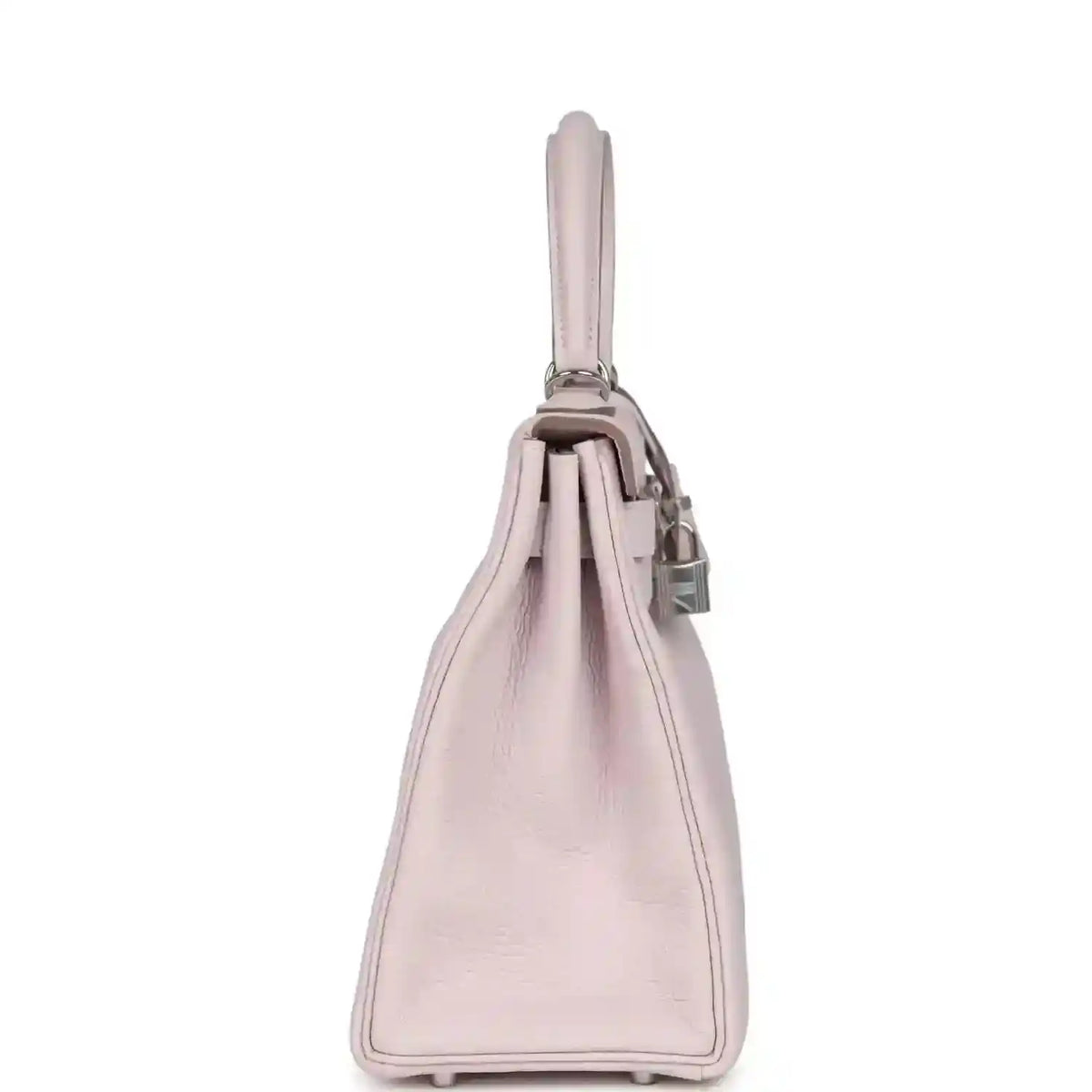 Light mauve leather handbag side view with top handle and stitched base corners