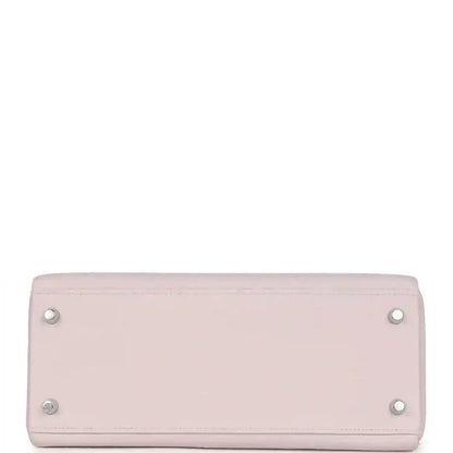 Light mauve leather handbag with silver snap buttons on back panel
