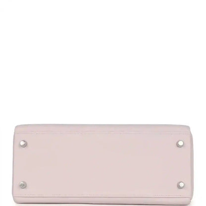 Light mauve leather handbag with silver snap buttons on back panel