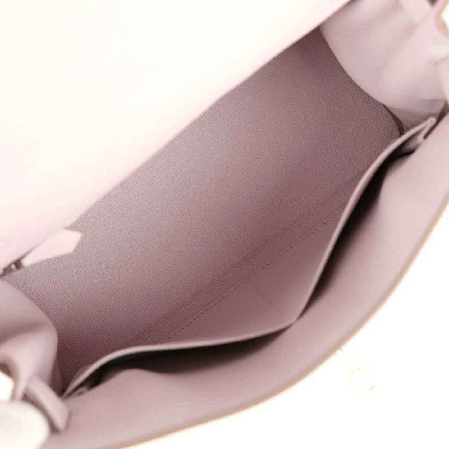 Light mauve leather handbag interior with visible lining and side pocket seam