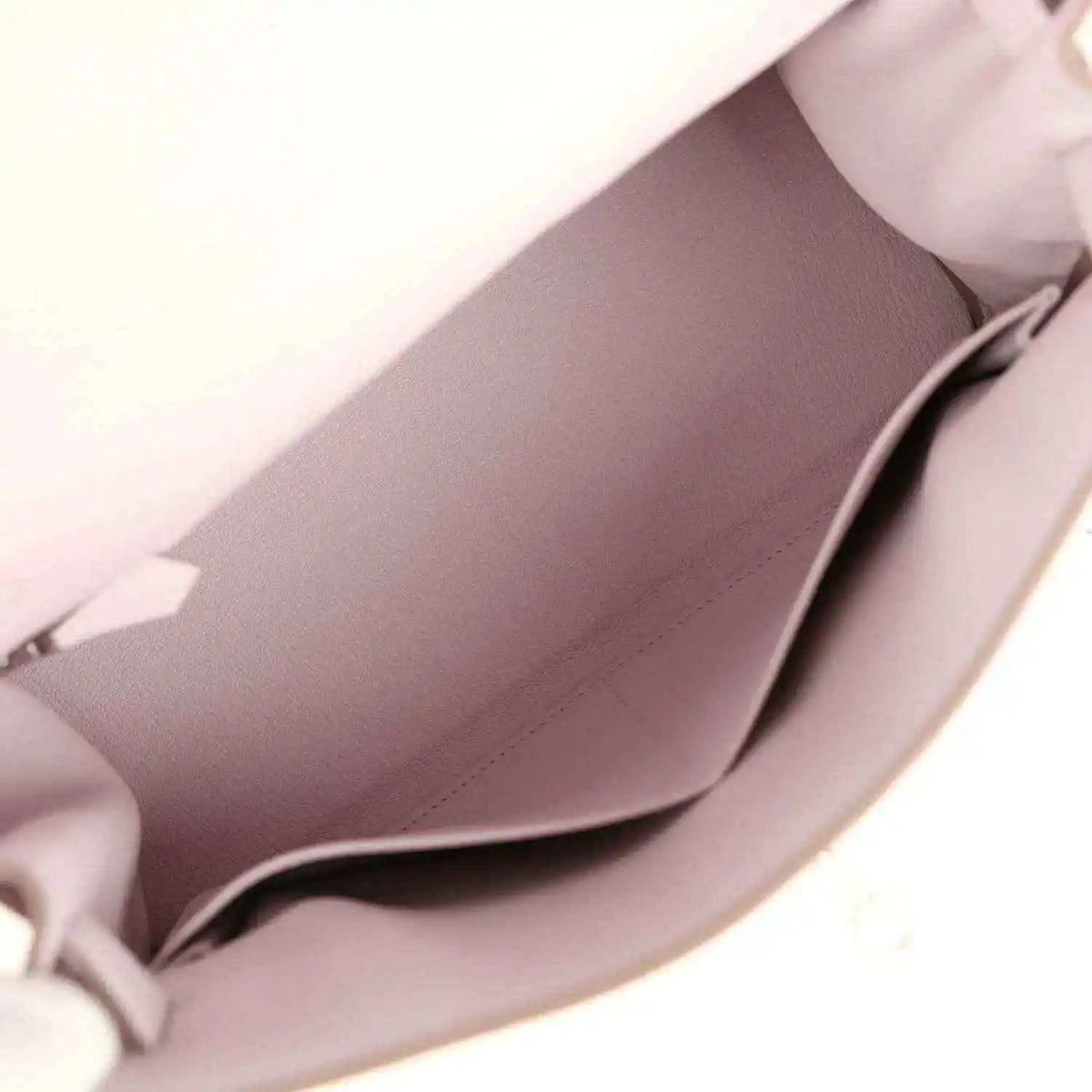 Light mauve leather handbag interior with visible lining and side pocket seam