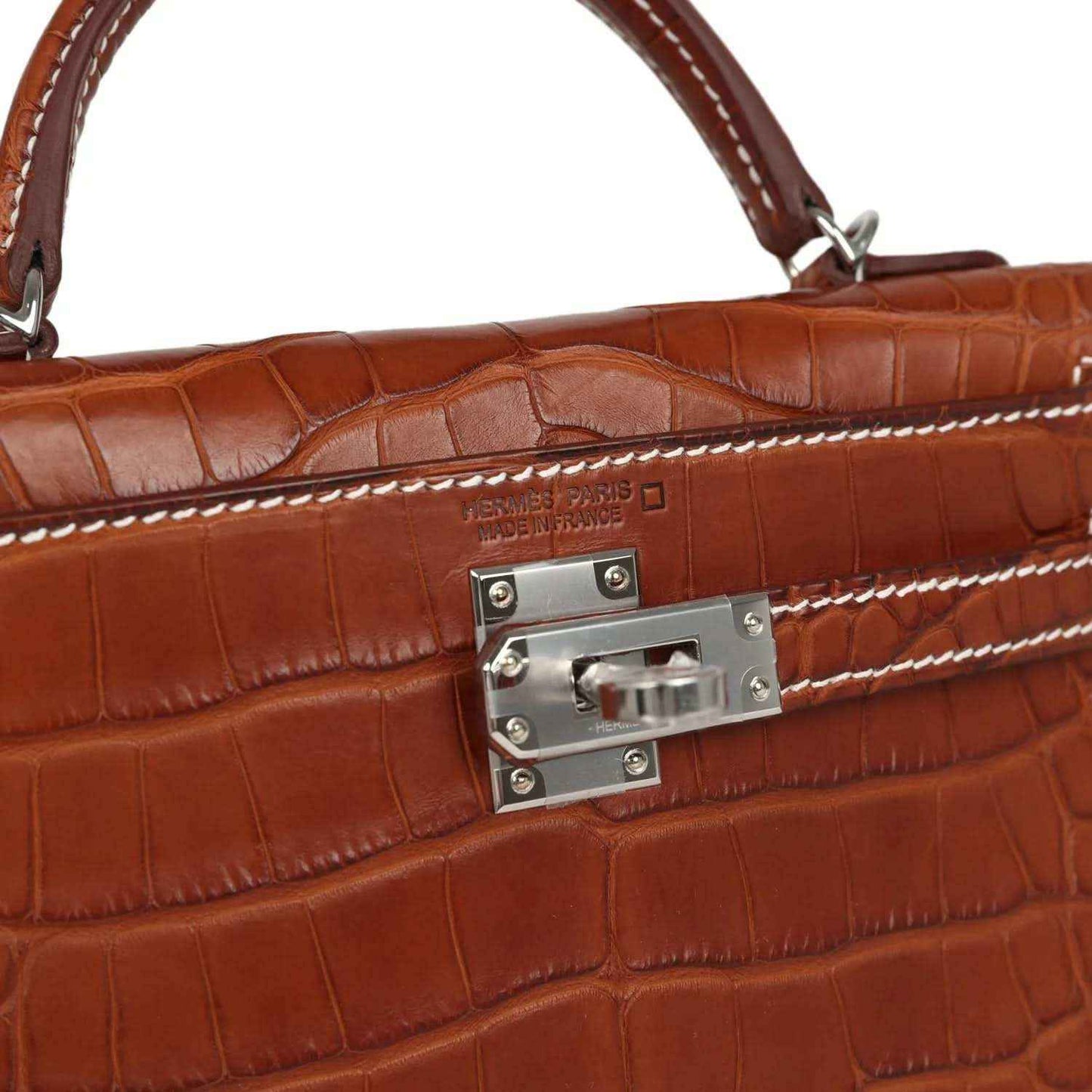 Hermes Kelly Sellier lock plate close-up on fauve croc leather