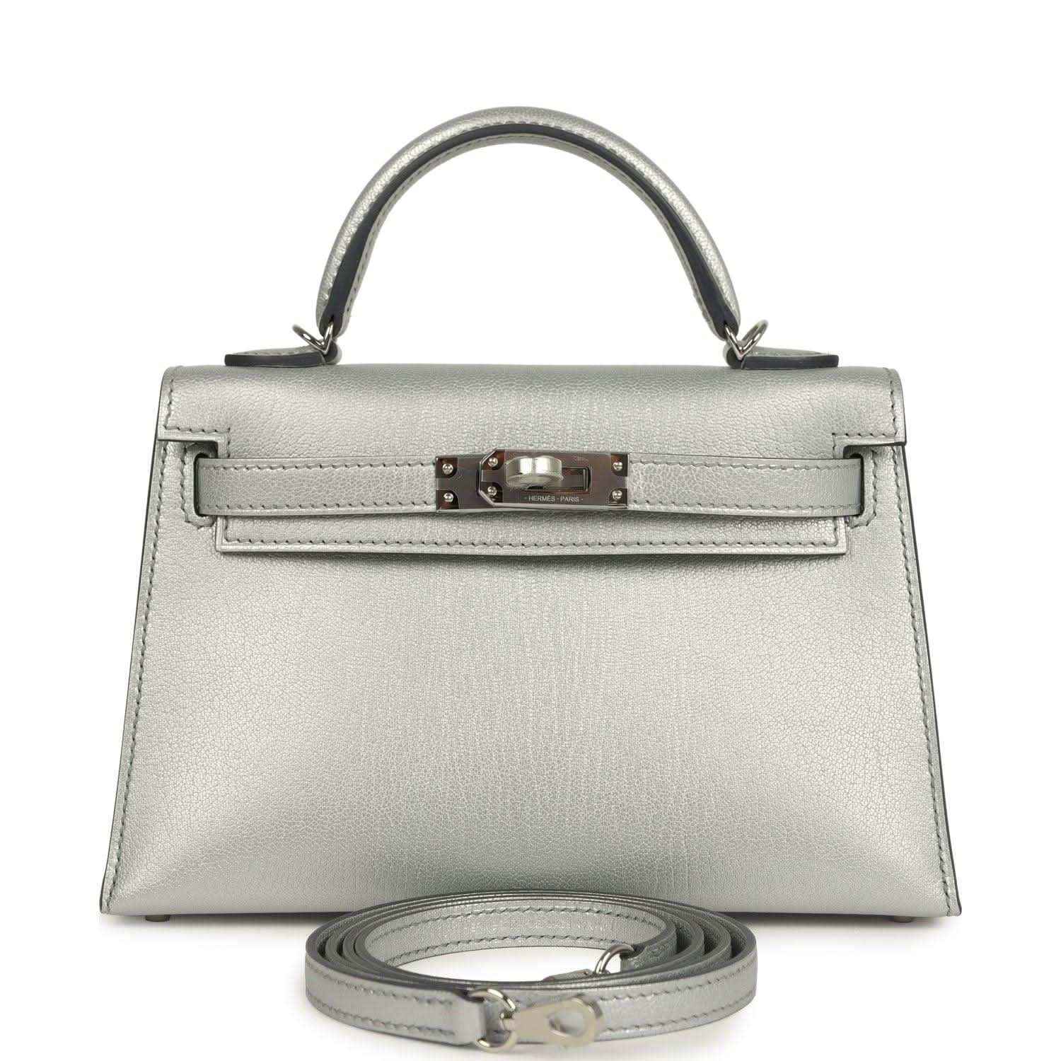 Silver mini handbag with top handle, front turn-lock and detachable strap
