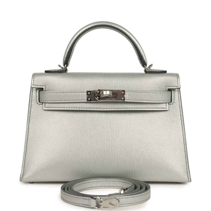 Silver mini handbag with top handle, front turn-lock and detachable strap