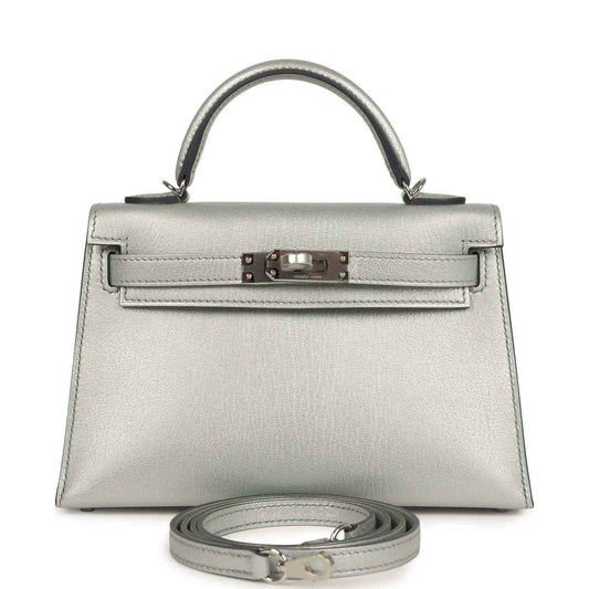 Silver mini handbag with top handle, front turn-lock and detachable strap