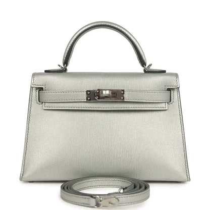 Silver mini handbag with top handle, front turn-lock and detachable strap