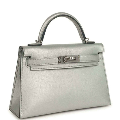 Light gray leather mini handbag with top handle and front turn-lock clasp
