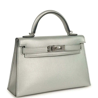 Light gray leather mini handbag with top handle and front turn-lock clasp