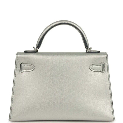 Light gray leather mini handbag with top handle and decorative front strap