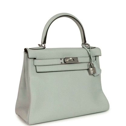 Light blue leather Kelly-style handbag with silver-tone clasp and structured top handle.