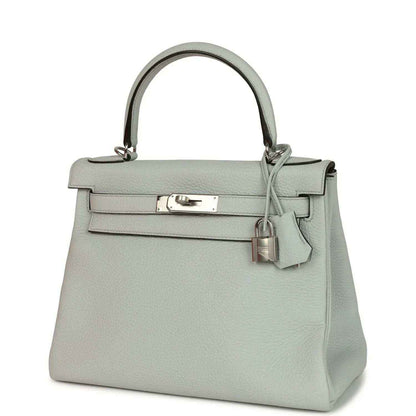Light blue leather Kelly-style bag with silver-tone clasp hardware and knotted top strap.