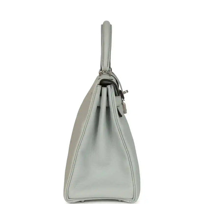 Light blue leather Kelly-style bag with side profile and top handle loop.