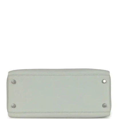 Light blue leather Kelly-style bag base with four metal feet and rounded corners.