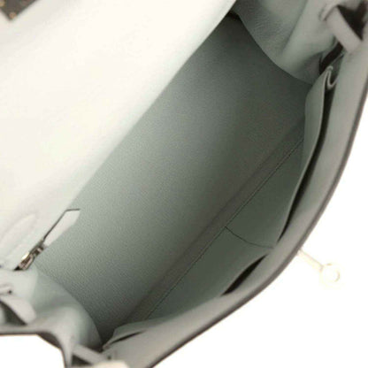 Light blue leather Kelly-style bag interior with smooth lining and side seam stitching.