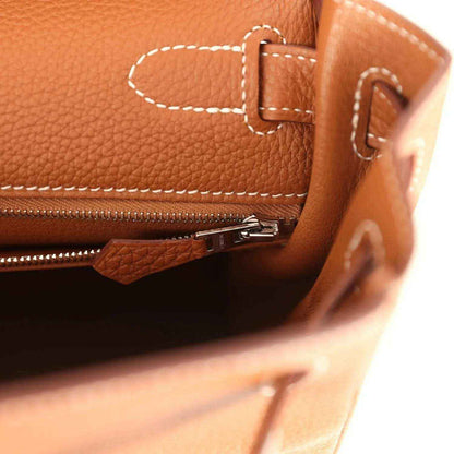 Hermes Kelly Retourne brown leather close-up with zipper track and turnlock hardware