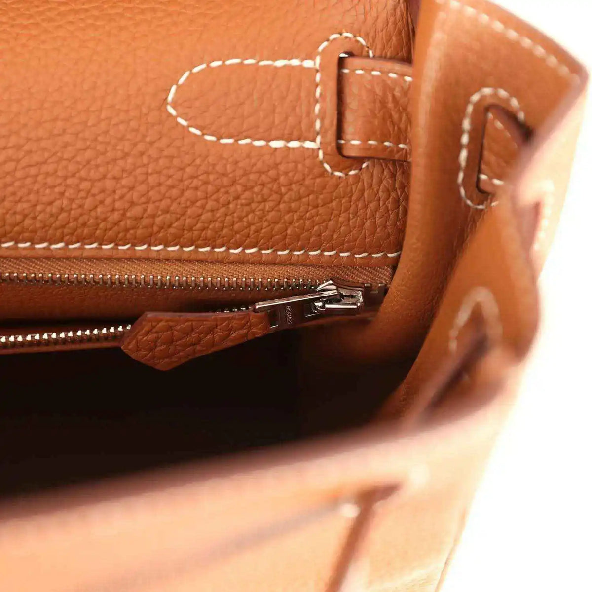 Hermes Kelly Retourne brown leather close-up with zipper track and turnlock hardware