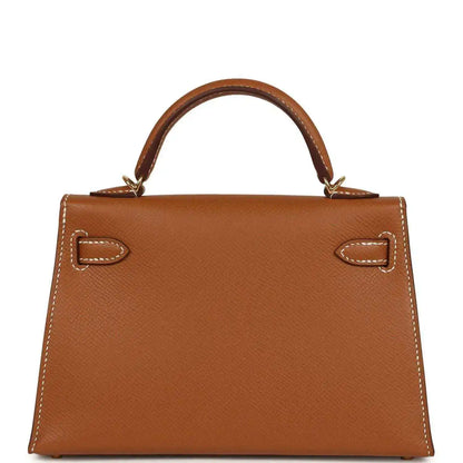 Tan textured leather mini handbag with top handles and gold front turn-lock