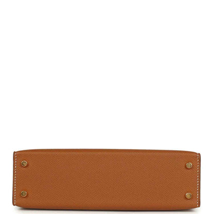 Tan textured mini handbag with four gold hardware studs at the base