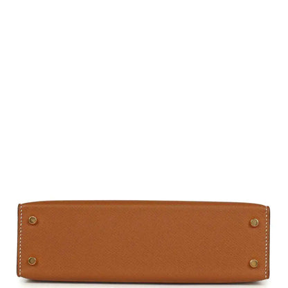 Tan textured mini handbag with four gold hardware studs at the base