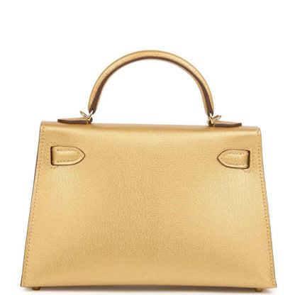 Kelly Sellier 20 handbag in gold leather, rear view with side pull tabs