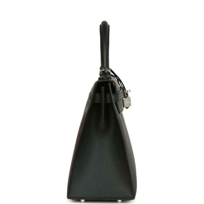 Structured leather handbag side view with top handle and metal lock hardware