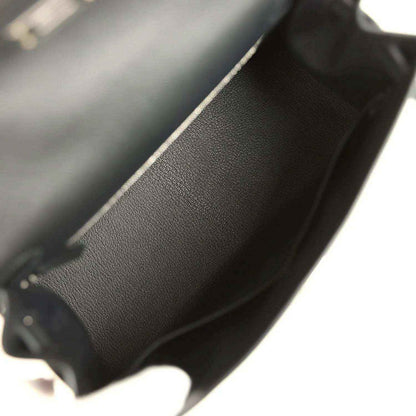 Close-up of textured leather handbag edge and interior seam along the side
