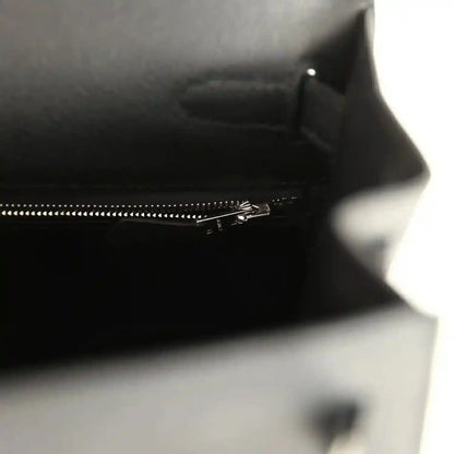 Close-up of interior zipper track along the top edge of the leather handbag