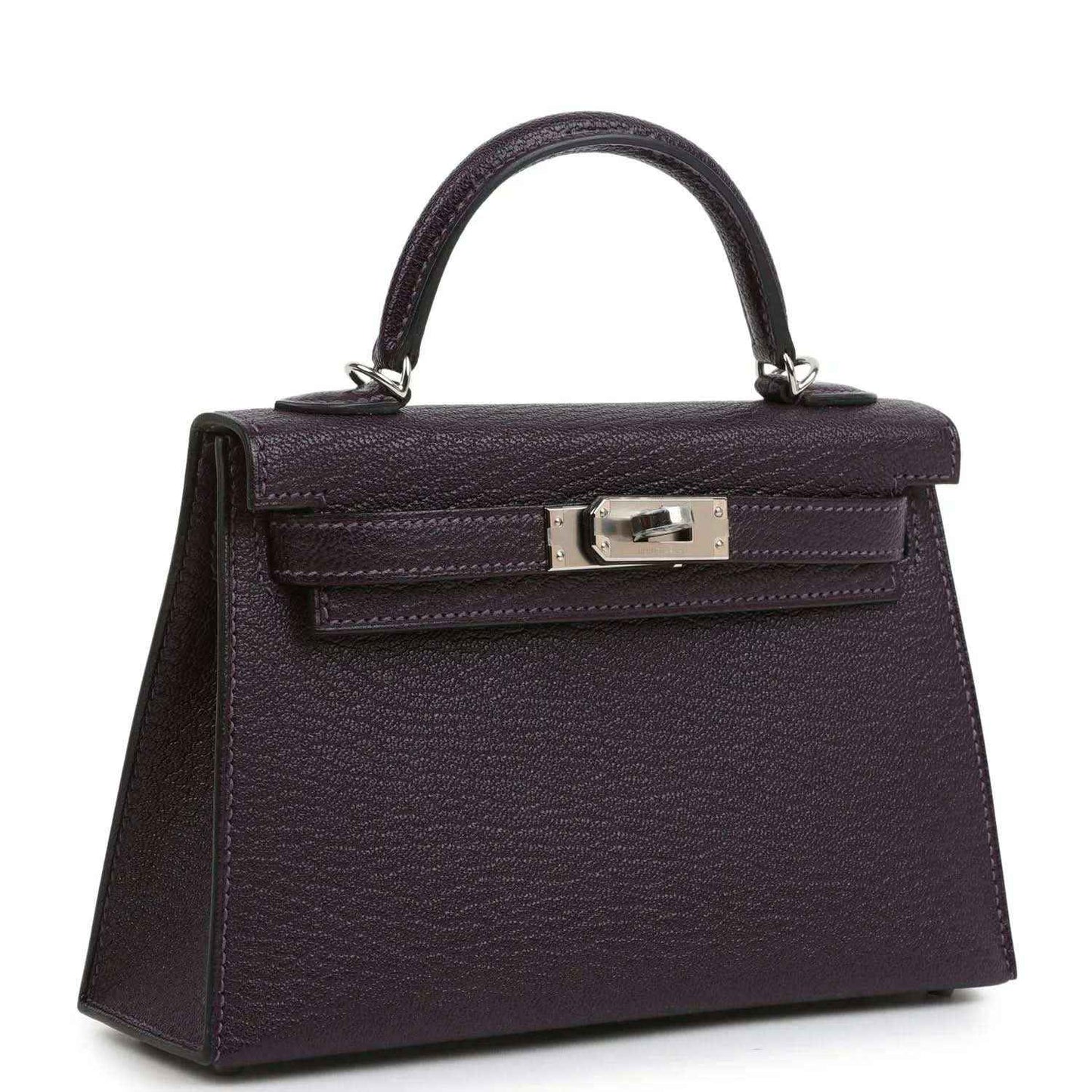 Purple leather handbag with top handle and front flap, metal clasp hardware.