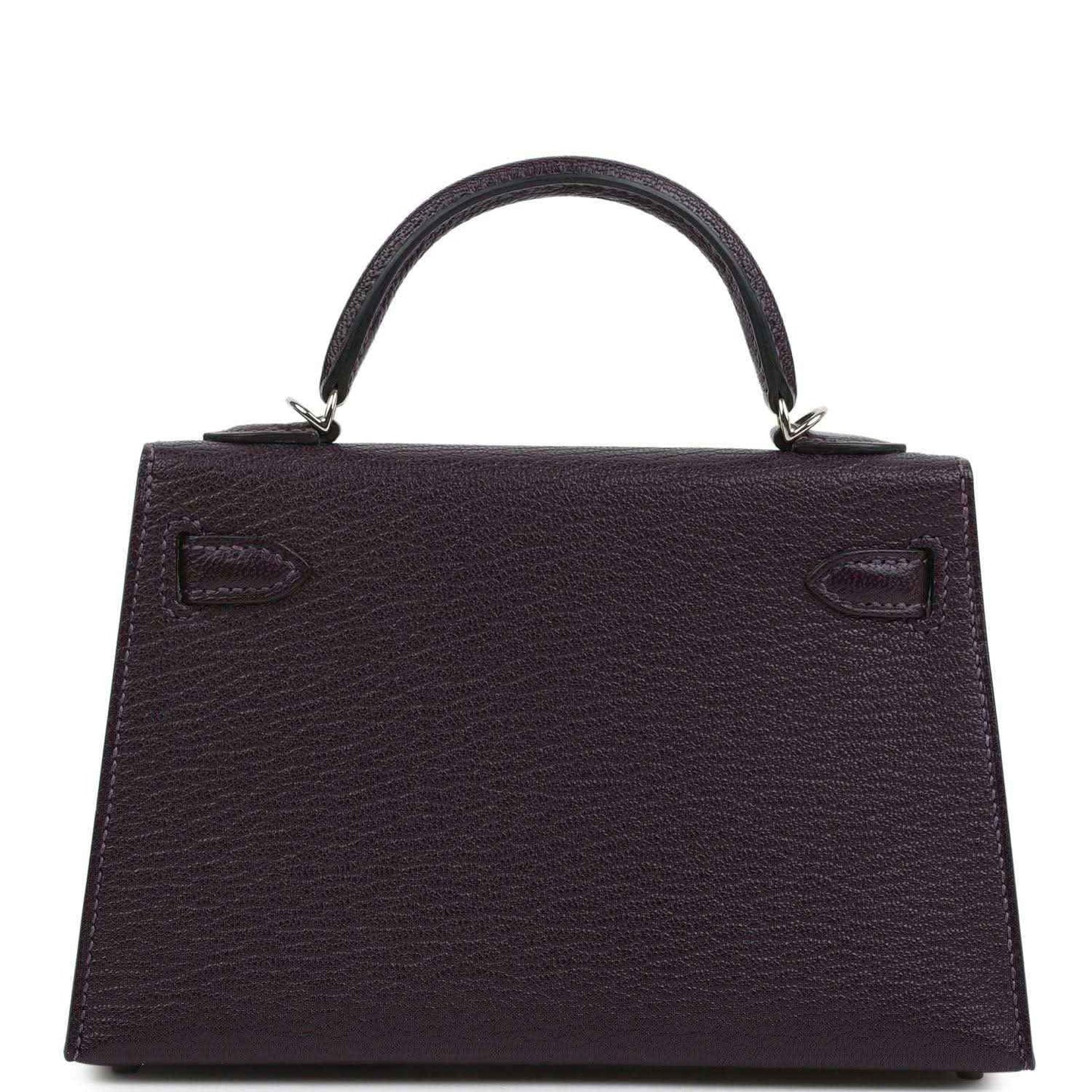 Purple leather handbag with top handle and back panel, embossed corner details.