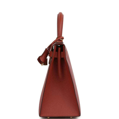 Red Kelly handbag back view with hanging leather tassels and gold feet