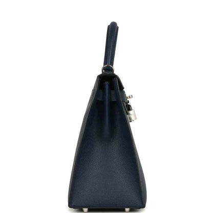 Hermes Kelly Sellier 28 handbag side view in dark blue pebbled leather with strap and lock