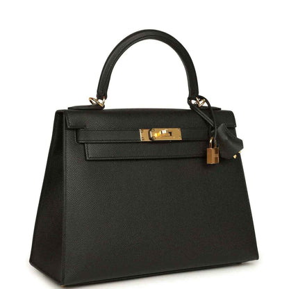 Black structured handbag with gold-tone front clasp and top handles