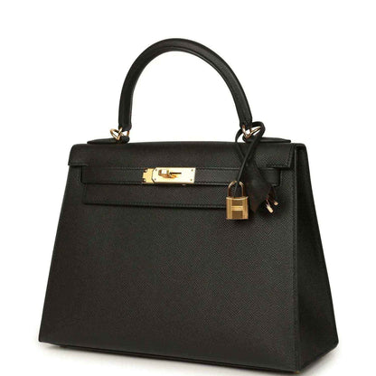 Black structured handbag with gold-tone front clasp and top handles