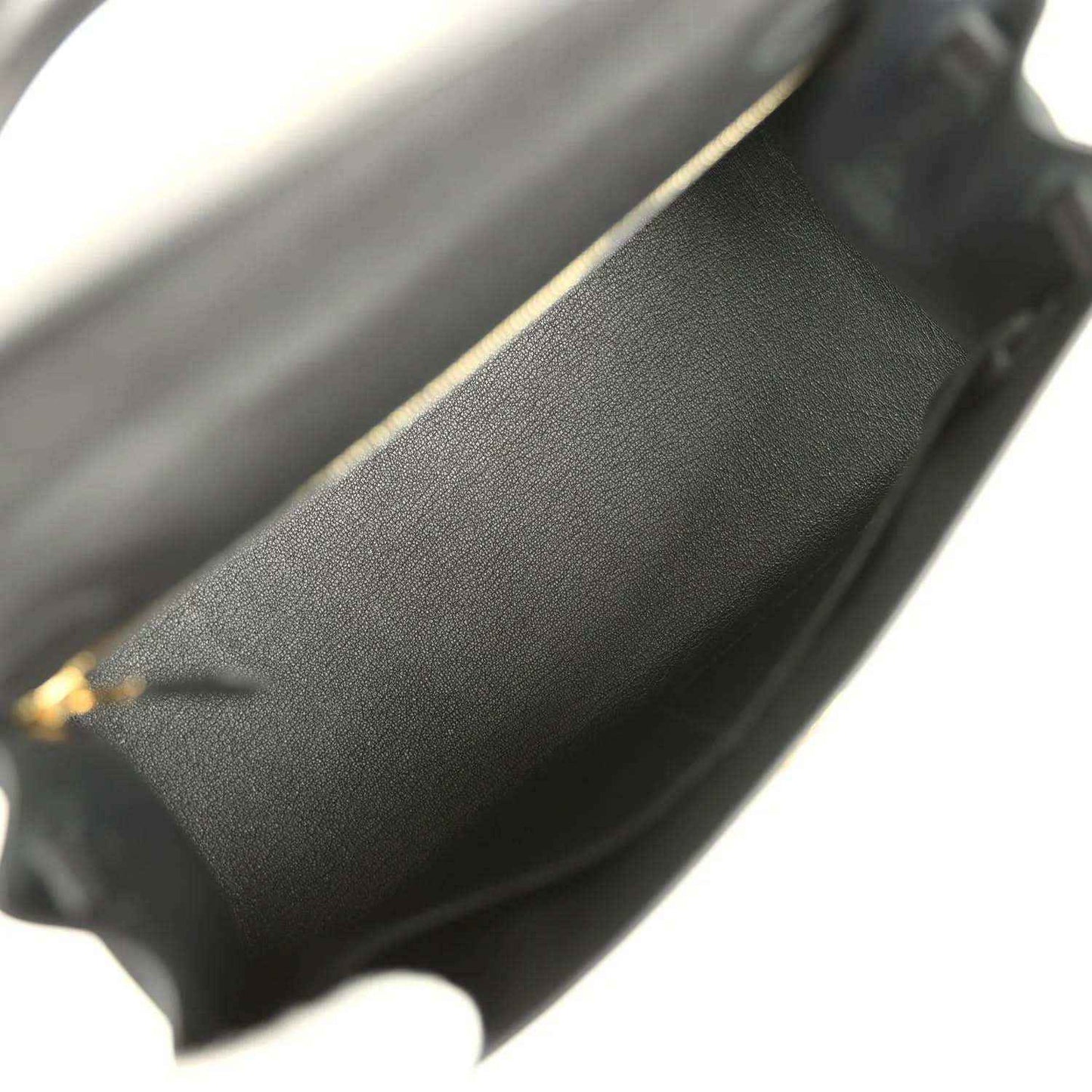 Black leather interior edge with gold-tone trim at the opening