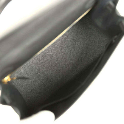 Black leather interior edge with gold-tone trim at the opening