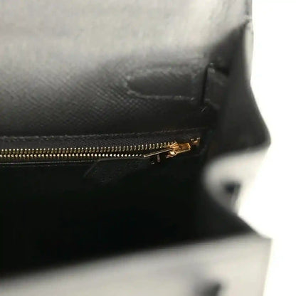 Black leather interior with gold-tone zipper and stitched lining