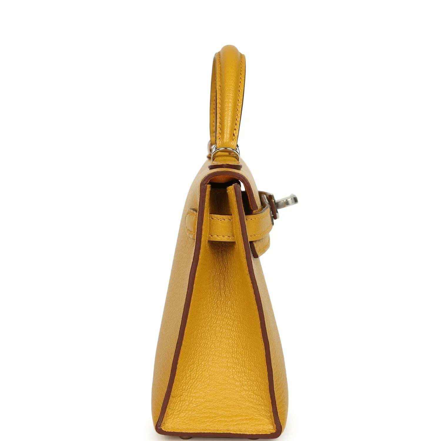 Yellow leather handbag side view with top handle and strap hardware, silver-tone details