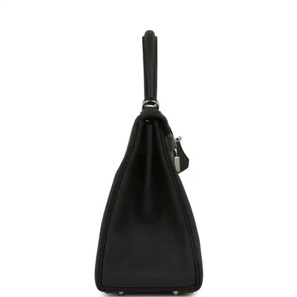 Black Togo leather Kelly bag side view with top handle and lock detail