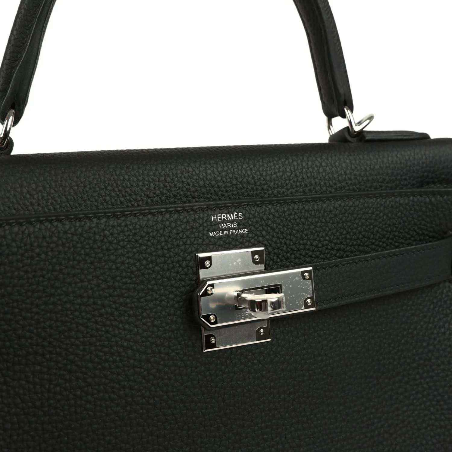 Metal clasp plate with HERMES stamp on black Togo leather Kelly bag