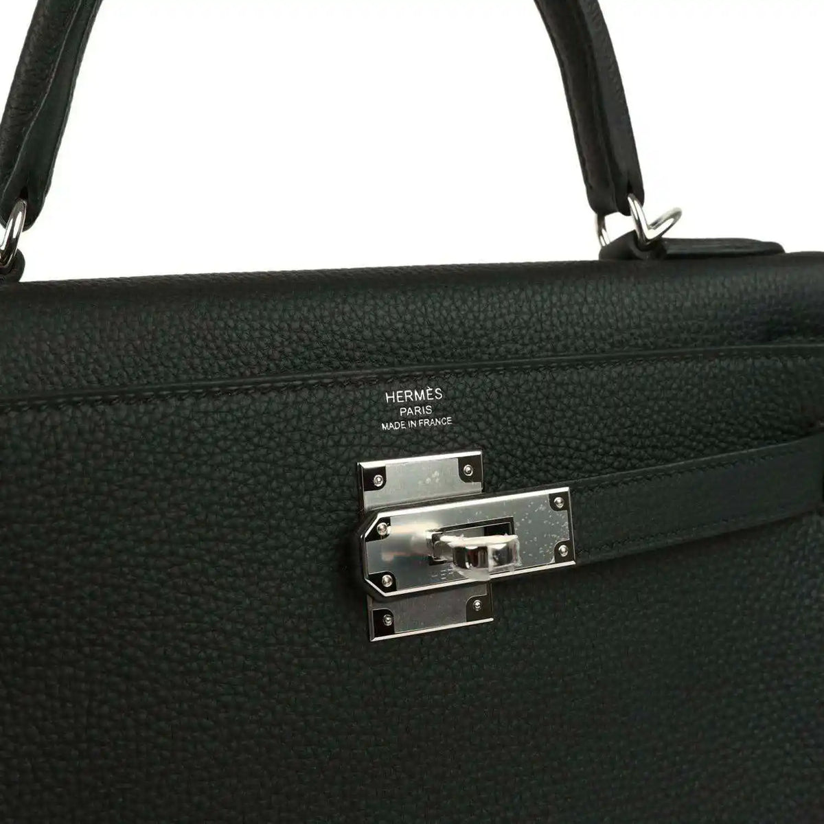 Metal clasp plate with HERMES stamp on black Togo leather Kelly bag